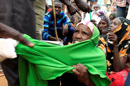 A newly arrived Somali refugee is forced out of the queue outside a reception centre in the Ifo 2 refugee camp in Dadaab, near the Kenya-Somalia border, in Garissa County, Kenya July 28, 2011. REUTERS/Thomas Mukoya/File Photo