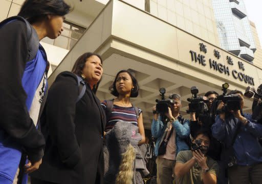 Indonesian Eni Lestari (2ndL) and members of the Asian Migrants' Coordinating Body stand outside of the High Court in Hong Kong. Hong Kong's court of appeal on Wednesday overturned a landmark ruling that opened the door for thousands of foreign maids to claim residency in the southern Chinese city
