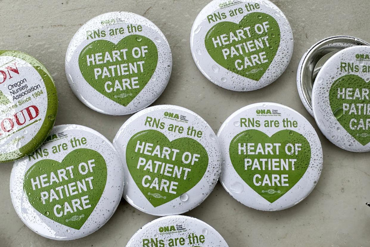 Wet buttons of support await as nurses and health care providers rally April 10 outside PeaceHealth Sacred Heart Medical Center at RiverBend in Springfield to demand more staffing.
