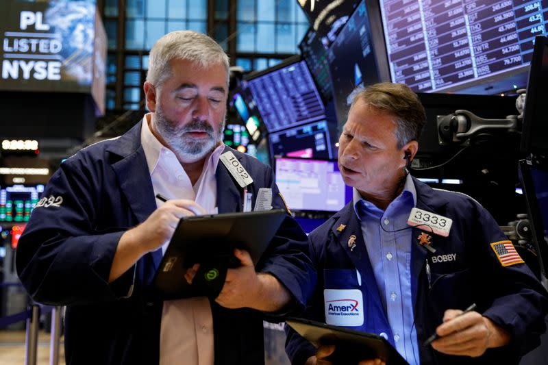 Traders work on the floor of the NYSE in New York