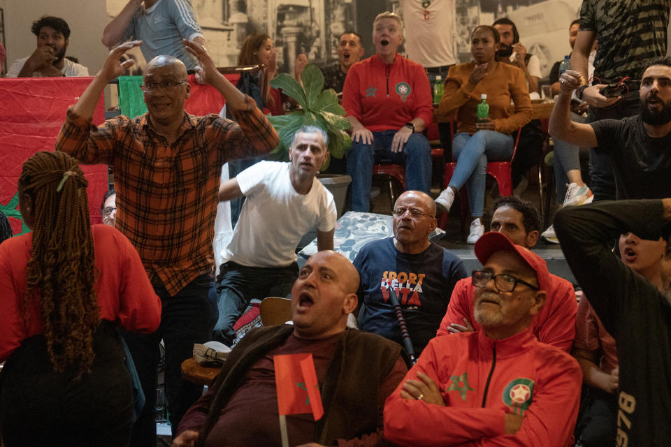 Moroccans and fans react as they watch in Johannesburg, South Africa, the World Cup semifinal soccer match between Morocco and France played in Qatar Wednesday, Dec. 14, 2022. France won 2-0 and moved to the final. (AP Photo/Shiraaz Mohamed)