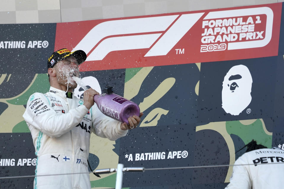 Mercedes driver Valtteri Bottas of Finland pours champagne to himself on the podium after winning the Japanese Formula One Grand Prix at Suzuka Circuit in Suzuka, central Japan, Sunday, Oct. 13, 2019. (AP Photo/Toru Hanai)