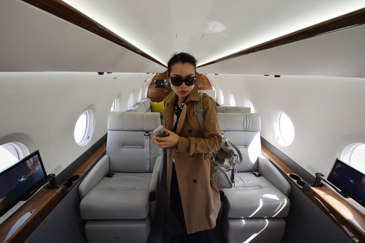 A Chinese businesswoman stands in a Gulfstream G150.