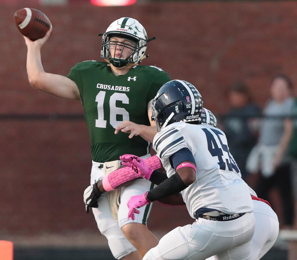 Central quarterback Jack Talkington throws downfield to a receiver with pressure from Kipp Academy's Zack Walton and  Malcolm Carter in the first half at Central.