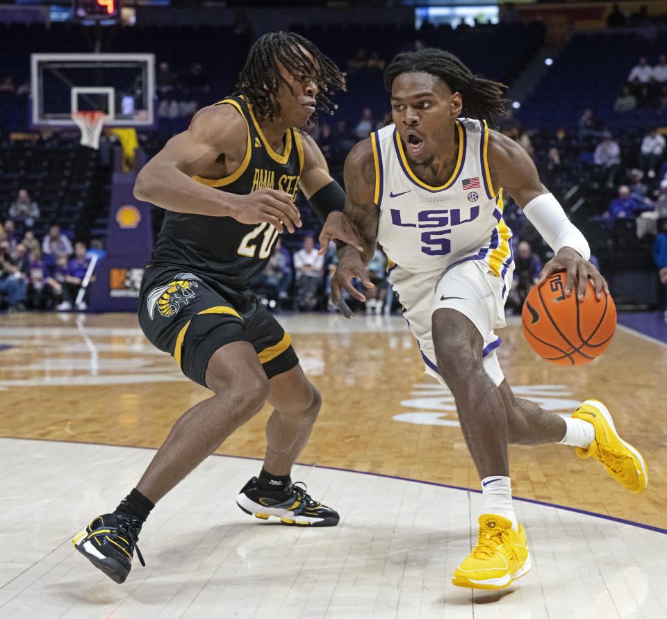 LSU forward Mwani Wilkinson (5) drives the ball around Alabama State guard TJ Madlock (20) during an NCAA college basketball game on Wednesday, Dec. 13, 2023, in Baton Rouge, La. (Hilary Scheinuk/The Advocate via AP)