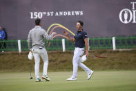 Rory McIlroy of Northern Ireland, left, and Viktor Hovland, of Norway, shake hands on the 18th green after their third round of the British Open golf championship on the Old Course at St. Andrews, Scotland, Saturday July 16, 2022. (AP Photo/Peter Morrison)