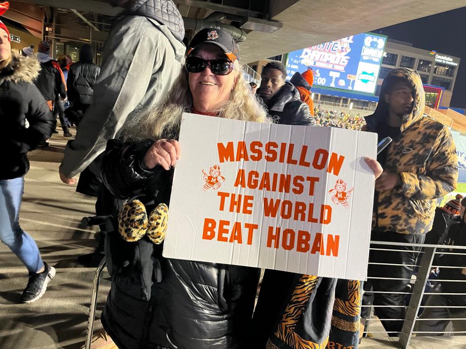 Betty Young of Massillon shows her "Massillon Against the World" at Tom Benson Hall of Fame Stadium Thursday night after the Massillon Tigers football team won the state championship.