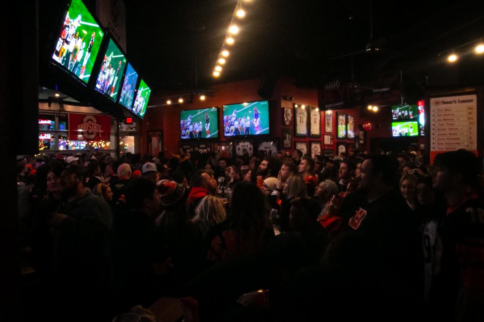 Bengals fans watch Super Bowl 56 from the Holy Grail Tavern and Grille, at The Banks, in downtown Cincinnati, on Feb. 13, 2022. Holy Grail features 31 high-definition TVs, an outdoor patio with a bar and a full-service food menu.