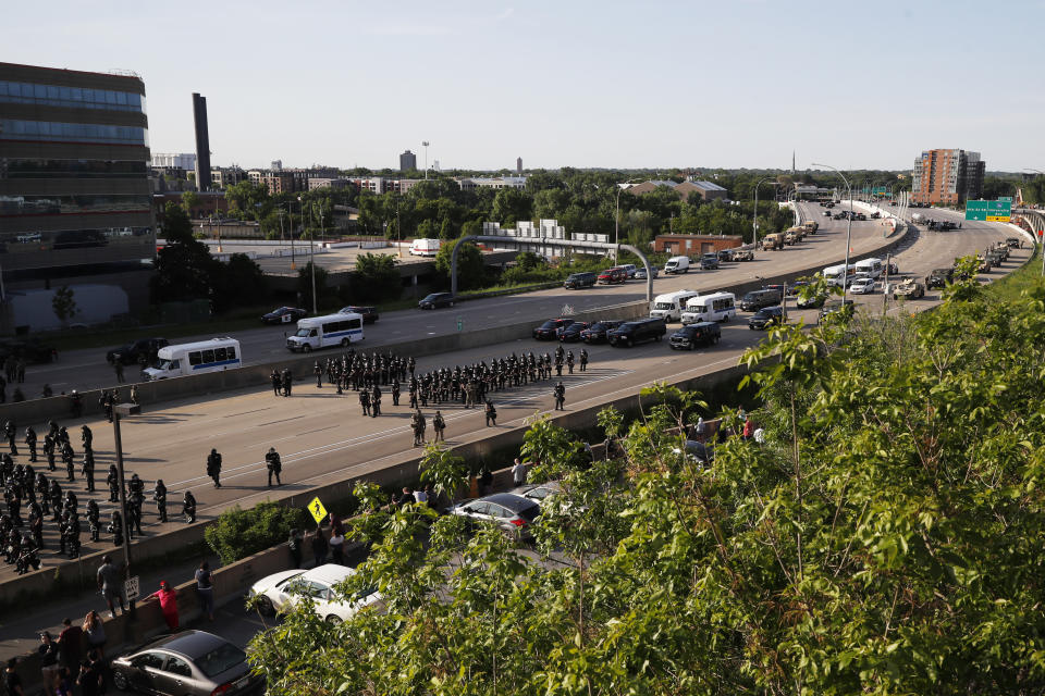 A police force prepares to clear an interstate of demonstrators Sunday, May 31, 2020, in Minneapolis. Protests continued following the death of George Floyd, who died after being restrained by Minneapolis police officers on Memorial Day. (AP Photo/John Minchillo)