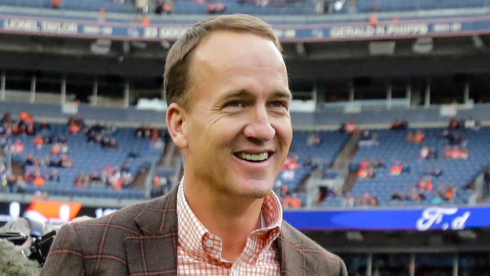 Mandatory Credit: Photo by Jack Dempsey/AP/Shutterstock (10779124a)Former Denver Broncos quarterback Peyton manning talks prior to an NFL football game between the Denver Broncos and the Houston Texans, in Denver.