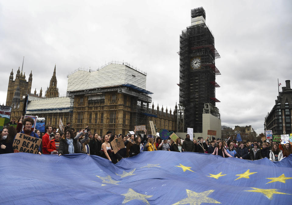 Students protest with a large EU flag on Westminster Bridge, London, Friday March 15, 2019. Students mobilized by word of mouth and social media skipped class Friday to protest what they believe are their governments’ failure to take though action against global warming. (Kirsty O'Connor/PA via AP)