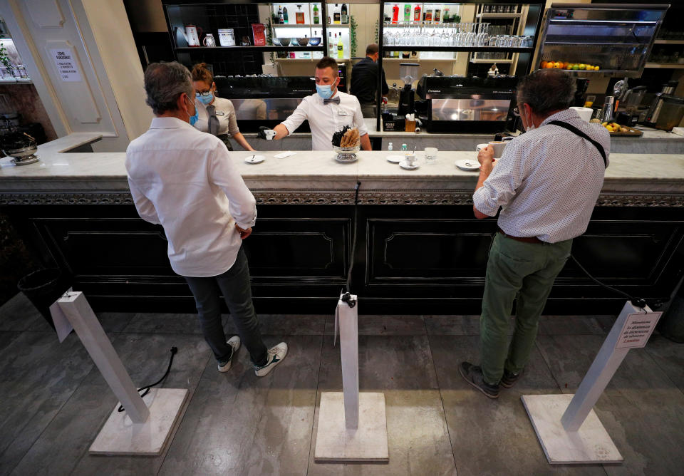 Customers enjoy their first visit to a cafe in Milan.