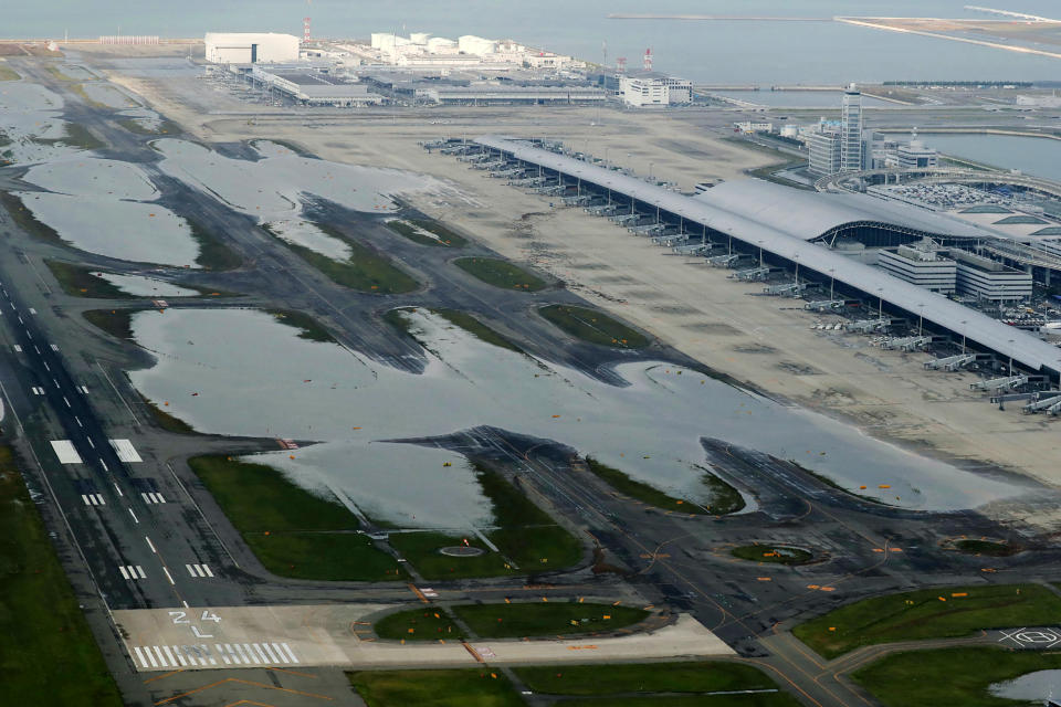 TOPSHOT - An aerial view from a Jiji Press helicopter shows flooding at the Kansai International Airport in Izumisano city, Osaka prefecture on September 5, 2018, after typhoon Jebi hit the west coast of Japan. - The toll in the most powerful typhoon to hit Japan in a quarter century rose on September 5 to nine, with thousands stranded at a major airport because of storm damage. (Photo by JIJI PRESS / JIJI PRESS / AFP) / Japan OUT        (Photo credit should read JIJI PRESS/AFP via Getty Images)