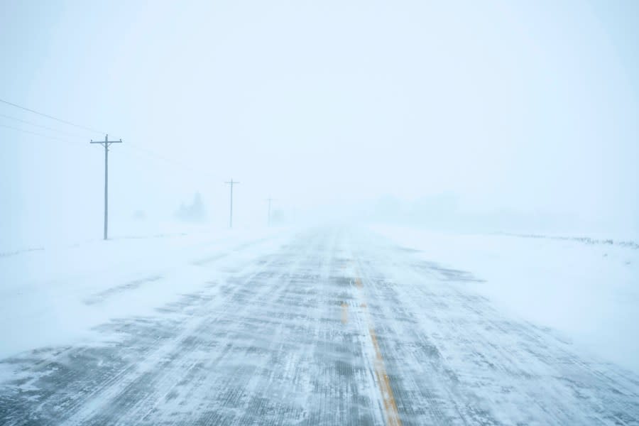Snow blows and drifts over County Road K22 near Merrill, Iowa, on Friday, Jan. 12, 2024. (AP Photo/Carolyn Kaster)
