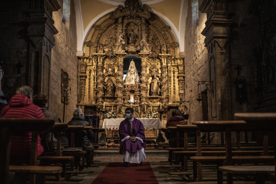 Salvadoran priest Edgardo Rivera, 42, talks to his parishioners at the Catholic church of Cazurra, a village of around 75 inhabitants, in the Zamora province of Spain, Saturday, Nov. 27, 2021. Overall, about 10% of the Catholic priests now serving in Spain were born elsewhere. The influx is welcome, given that the average age for a priest in Spain today is about 65. (AP Photo/Manu Brabo)