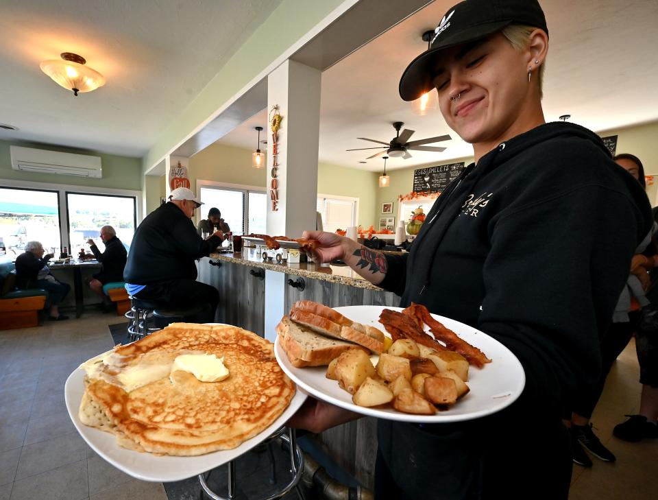 Brody's Diner server Taylor Loconto carries three plates during the breakfast shift Wednesday.
