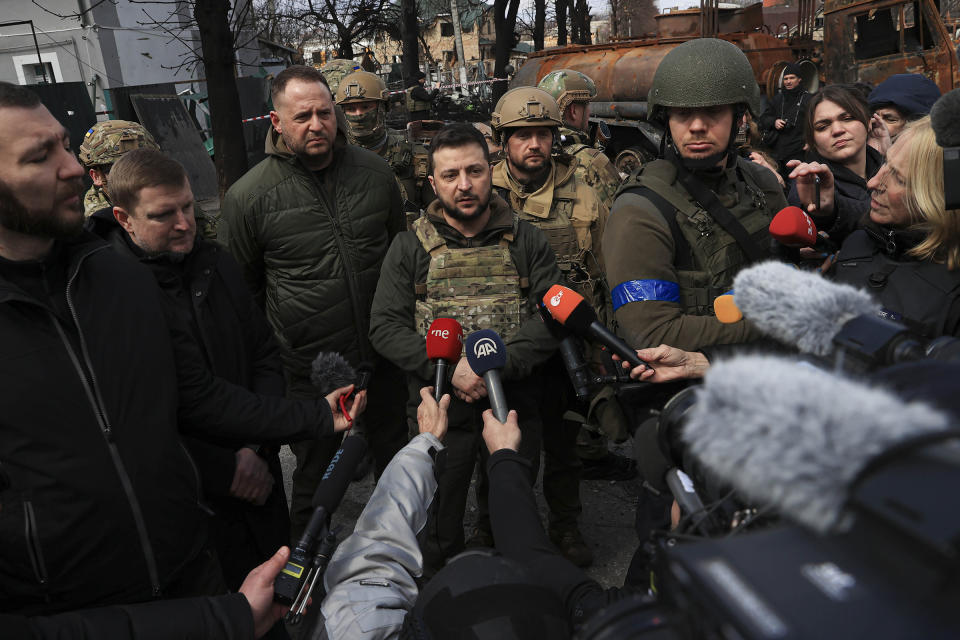 Zelensky, with his chief of staff Andriy Yermak, center, speaks to journalists in Bucha on April 4<span class="copyright">Metin Aktas—Anadolu Agency/Getty Images</span>