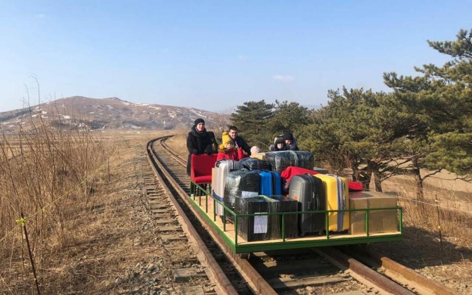 Russian diplomats and family members leave North Korea to Russia using a hand-pushed rail trolley due to Pyongyang's coronavirus restrictions -  AFP