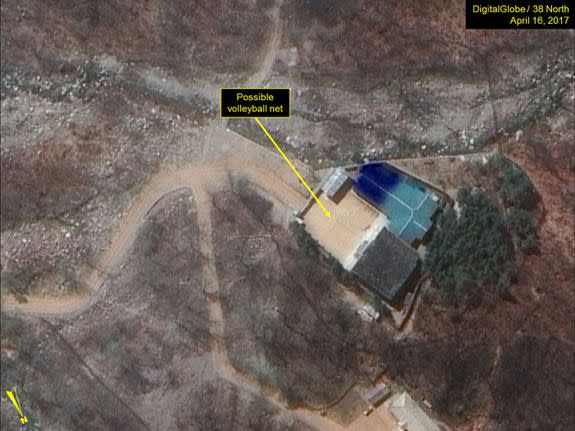 <p>North Korea's military has been spotted seemingly playing a game of volleyball at the main Punggye-ri nuclear test site.</p> <p>Satellite images of the site appear to show two six-player teams facing each other, with a net between them.</p> <p>Joseph Bermudez, an analyst for non-profit <a rel="nofollow noopener" href="http://38north.org/2017/04/punggye041917/" target="_blank" data-ylk="slk:38 North;elm:context_link;itc:0;sec:content-canvas" class="link ">38 North</a>, which first noticed the pictures, said multiple games were going on at the facility — at the administrative area, the support area, the command centre, and at the guard barracks.</p>  <p>A possible volleyball net seen in the command center area</p><div><p>Image: DigitalGlobe/Getty Images</p></div> <p>A probable volleyball game seen at the guard barracks at Punggye-ri</p><div><p>Image: DigitalGlobe/Getty Images</p></div><p>The people appear to be standing in formations consistent with volleyball games, he added.</p> <p>But if you thought the North Koreans were taking a break, it's more likely that the games were staged knowing the outside world is looking.</p>  <p>PUNGGYE-RI NUCLEAR TEST SITE, NORTH KOREA - APRIL 16, 2017. Figure 4. Probable volleyball game seen at the command center support area. (Photo DigitalGlobe/38 North via Getty Images)</p><div><p>Image: DigitalGlobe/Getty Images</p></div><p>Analysts <a rel="nofollow noopener" href="https://www.nytimes.com/2017/04/19/world/asia/north-korea-nuclear-test-volleyball.html" target="_blank" data-ylk="slk:told the New York Times;elm:context_link;itc:0;sec:content-canvas" class="link ">told the <em>New York Times</em></a> that the games were probably intended to send a message, as North Korea knows that the Punggye-ri test site is under intense scrutiny.</p> <p>The games could be North Korea's way of indicating that it's pausing its controversial nuclear missile testing activity — or that it's making it seem like it has.</p> <p>Both <a rel="nofollow noopener" href="http://www.fmprc.gov.cn/mfa_eng/xwfw_665399/s2510_665401/2511_665403/t1454907.shtml" target="_blank" data-ylk="slk:China;elm:context_link;itc:0;sec:content-canvas" class="link ">China</a> and <a rel="nofollow noopener" href="https://www.washingtonpost.com/world/asia_pacific/pence-makes-surprise-stop-to-demilitarized-zone-during-korea-trip/2017/04/16/e1da822e-230e-11e7-a1b3-faff0034e2de_story.html?tid=ptv_rellink&utm_term=.fb6a67e47a51" target="_blank" data-ylk="slk:the U.S.;elm:context_link;itc:0;sec:content-canvas" class="link ">the U.S.</a> have raised condemnation of the hermit country's nuclear tests in recent weeks, as Trump places pressure on the North to halt its missile activity.</p> <p>"While strongly suggestive of the completion of preparations for a sixth nuclear test, the imagery alone does not provide any definitive evidence of the installation of a nuclear device or indication of the specific timing for such an event," Bermudez told <em>Mashable</em>.</p> <p>Volleyball games are a normal occurrence at Punggye-ri, according to Melissa Hanham, an analyst at the Middlebury Institute of International Studies in Monterey, California. The game is a popular sport in North Korea. </p> <p>"It doesn't mean anything other than people are there and [that] they are bored," Hanham said in an email to <em>Mashable. </em></p> <p>Both Hanham and Bermudez agreed that the site could still be ready for a nuclear test. </p> <p>38 North described the site as "primed and ready" <a rel="nofollow noopener" href="http://38north.org/2017/04/punggyeri041217/" target="_blank" data-ylk="slk:on April 12;elm:context_link;itc:0;sec:content-canvas" class="link ">on April 12</a>, and a UN representative of the reclusive dictatorship confirmed that a new nuclear test was <a rel="nofollow noopener" href="http://www.channelnewsasia.com/news/asiapacific/north-korea-says-ready-to-react-to-any-mode-of-war-from-us/3685330.html" target="_blank" data-ylk="slk:under preparation;elm:context_link;itc:0;sec:content-canvas" class="link ">under preparation</a>. </p> <p><a rel="nofollow noopener" href="http://www.channelnewsasia.com/news/asiapacific/tensions-high-north-korea-readies-nuclear-test-report/3674450.html" target="_blank" data-ylk="slk:Analysts speculated;elm:context_link;itc:0;sec:content-canvas" class="link ">Analysts speculated</a> that the reclusive dictatorship could trigger a nuclear test to mark the 105th birth anniversary of the country's founding leader, Kim Il-Sung, which occurred last Saturday. Kim Il-Sung's grandson, Kim Jong-un, is North Korea's current leader.</p> <p>"The ultimate choice as to whether to test, or not to test, rests solely in the hands of Kim Jong-un," Bermudez said.</p> <div> <h2>WATCH: Scientists discovered a rare giant black worm monster in the Philippines</h2>  </div>