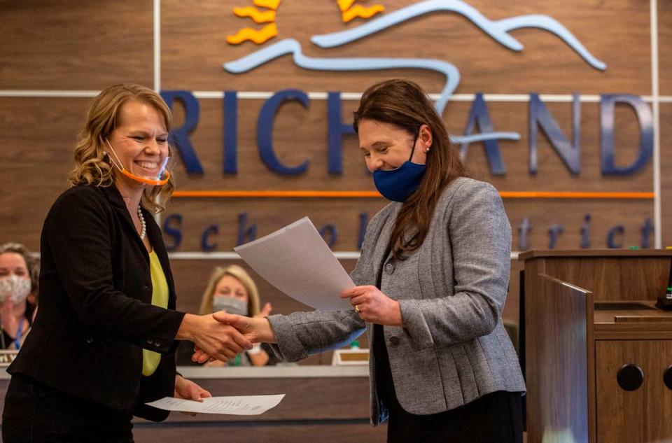 Audra Byrd shakes hands with district Superintendent Shelley Redinger after Byrd was sworn in as a new Richland School Board member in November.