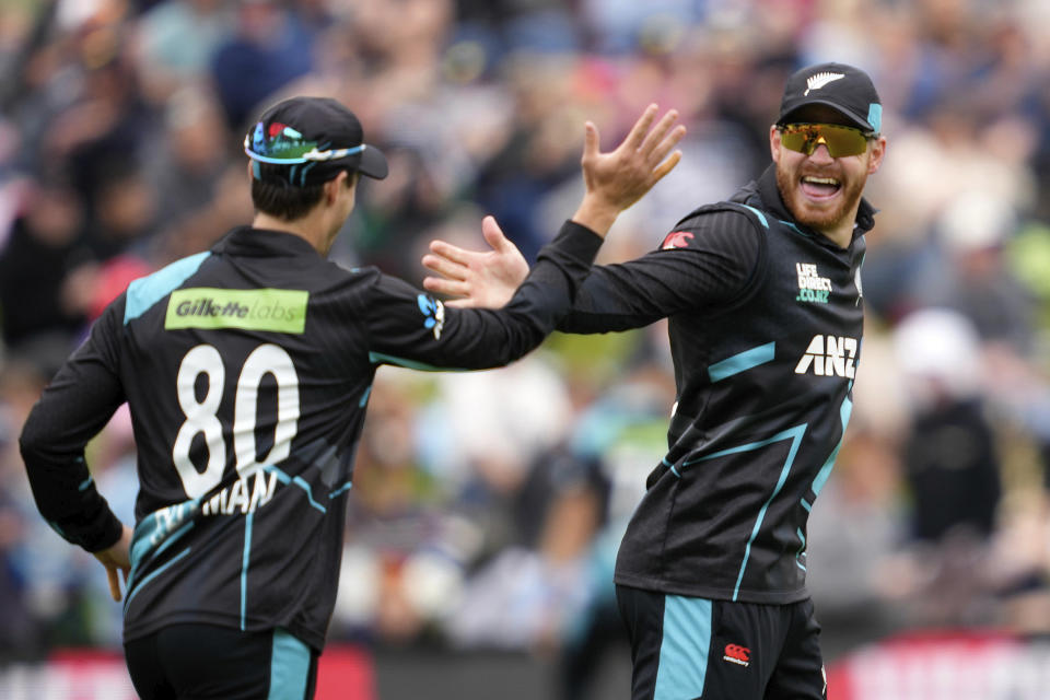New Zealand's Glenn Phillips, right, celebrates with a teammate during their T20international cricket match against Pakistan in Dunedin, New Zealand, Wednesday, Jan. 17, 2024. (Michael Thomas/Photosport via AP)