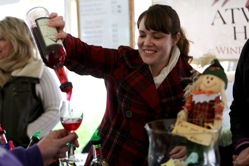 Andrea Klare pours a sample of Atwood Hill wine during the Northern Kentucky Wine Festival.