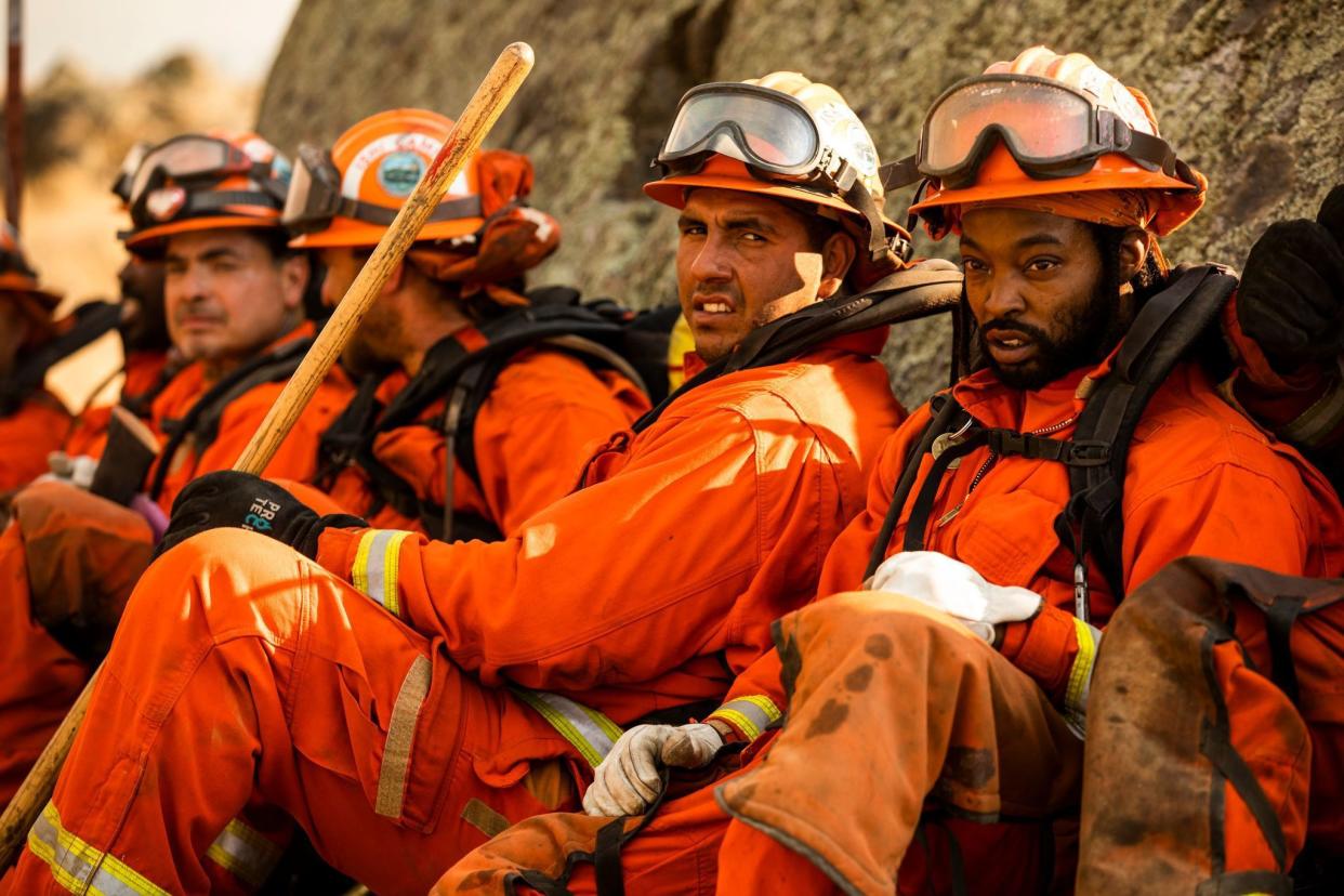 A crew of inmate firefighters take a break during firefighting operations to battle the Kincade Fire in Healdsburg, Calif. on Oct. 26, 2019.
