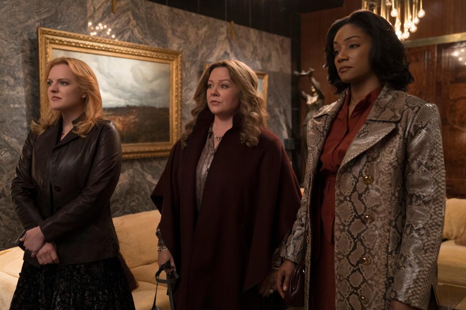 Elisabeth Moss (far left), Melissa McCarthy and Tiffany Haddish play mob wives who make the most of their turn at gangland success in 