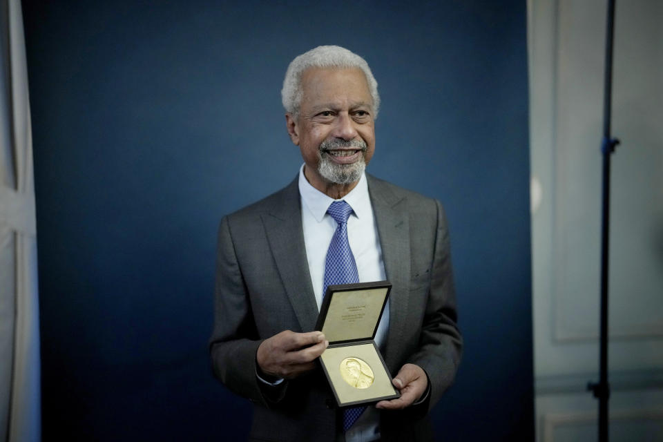 Abdulrazak Gurnah, a Tanzanian-born novelist and emeritus professor who lives in the UK, poses for photographs with his 2021 Nobel Prize for Literature medal after being presented it by the Ambassador of Sweden Mikaela Kumlin Granit in a ceremony at the Swedish Ambassador's Residence in London, Monday, Dec. 6, 2021. The 2021 Nobel Prize ceremonies are being reined in and scaled-down for the second year in a row due to the coronavirus pandemic, with the laureates receiving their Nobel Prize medals and diplomas in their home countries. (AP Photo/Matt Dunham)