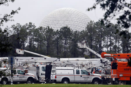 The 'Spaceship Earth' dome looms above a fleet of utility trucks parked in a parking lot at Disney's Epcot theme park ahead of the arrival of Hurricane Irma in Kissimmee, Florida, U.S., September 10, 2017. REUTERS/Gregg Newton