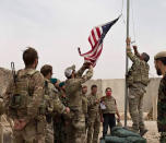 FILE - In this May 2, 2021 file photo, a U.S. flag is lowered as American and Afghan soldiers attend a handover ceremony from the U.S. Army to the Afghan National Army, at Camp Anthonic, in Helmand province, southern Afghanistan. The US and NATO have promised to pay $4 billion a year until 2024 to finance Afghanistan’s military and security forces, which are struggling to contain an advancing Taliban. Already since 2001, the U.S. has spent nearly $89 billion to build, equip and train the forces. (Afghan Ministry of Defense Press Office via AP, File)