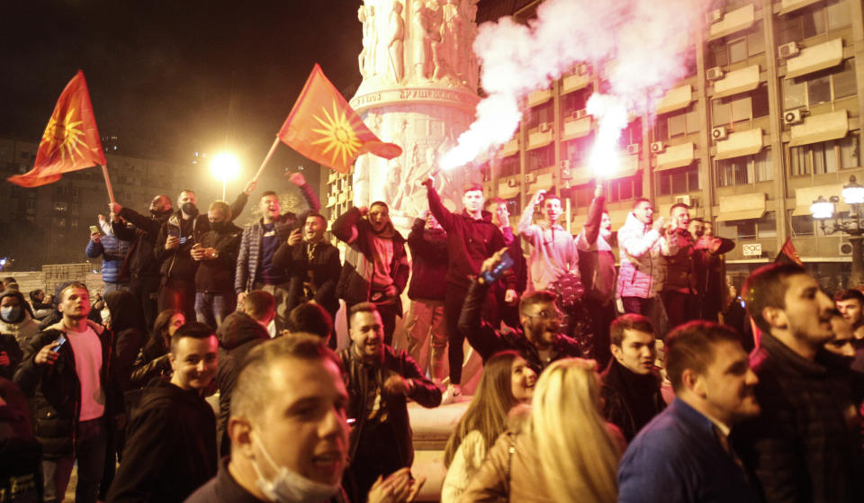 Supporters of the opposition VMRO-DPMNE party celebrate the victory on the local elections at the party headquarters in Skopje, North Macedonia, late Sunday, Oct. 31, 2021. North Macedonia's Prime Minister Zoran Zaev announced his resignation as prime minister and leader of Social-democratic Union after oppositional center-right coalition won a landslide victory on local elections. (AP Photo/Boris Grdanoski)