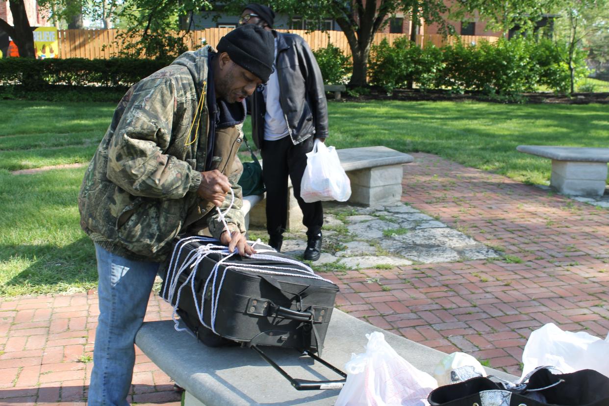 Orville Sharp III packs up food he received from the Broad Street Presbyterian Church food pantry into his suitcase and bags on May 9, 2022. He has no vehicle and has to haul any food by foot back to his residence.