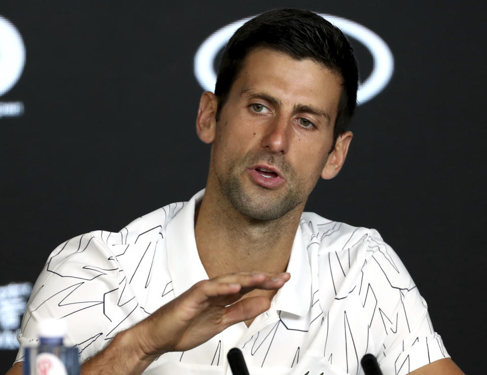 Serbia's Novak Djokovic gestures during a press conference ahead of the Australian Open tennis championship in Melbourne, Australia, Sunday, Jan. 19, 2020. (AP Photo/Dita Alangkara)