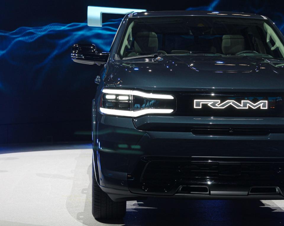 A close-up shot of the 2024 Ram 1500 REV pickup truck against a blue background.