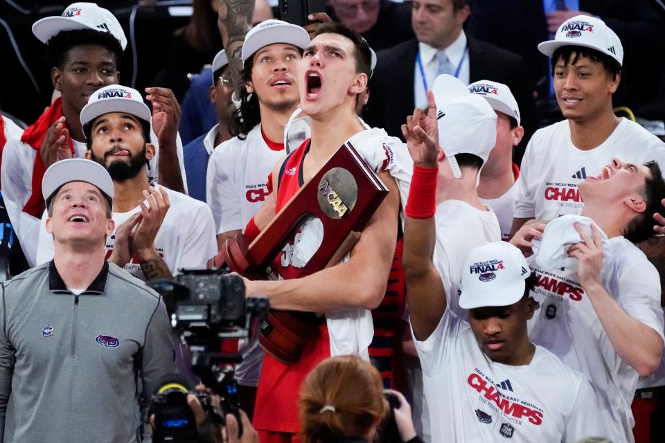 Florida Atlantic's Vladislav Goldin, center, celebrates after the Owls beat Kansas State in the NCAA men's tournament.