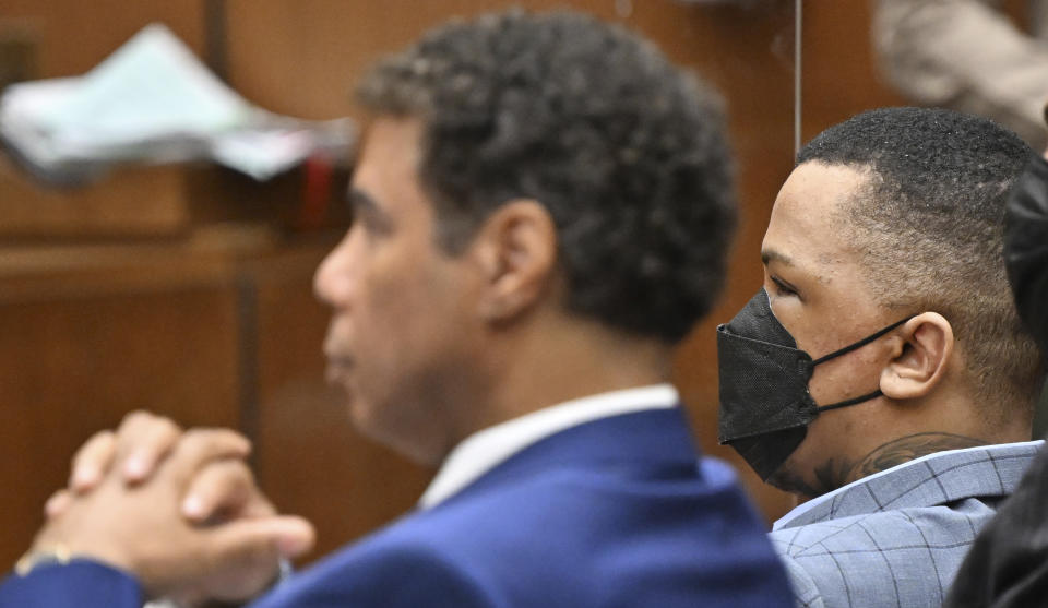 Eric Holder, right, looks on, while seated beside his attorney Aaron Jensen, during closing arguments at his trial on Thursday, June 30, 2022, in Los Angeles. (Frederic J. Brown/Pool Photo via AP)