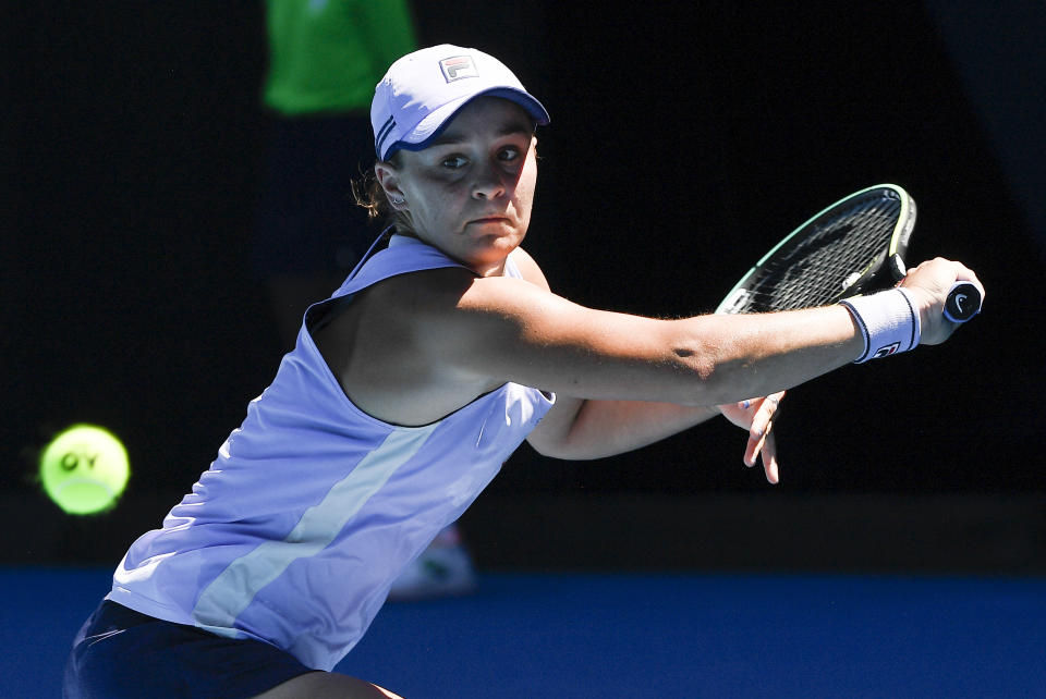 Australia's Ash Barty hits a backhand return to Karolina Muchova of the Czech Republic during their quarterfinal match at the Australian Open tennis championship in Melbourne, Australia, Wednesday, Feb. 17, 2021.(AP Photo/Andy Brownbill)