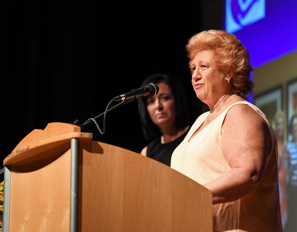 Patti Hicks speaks to an audience gathered in the Ravenna High School auditorium after receiving the 2023 Lifetime Achievement Award during the 2024 Raven Award ceremony on Wednesday, June 5, 2024, in Ravenna.