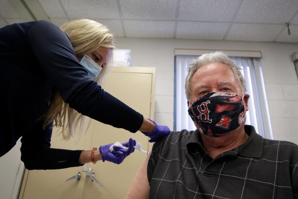 Nurse Erin Roan gives Joe Morris of Warwick a vaccine booster shot at the Pilgrim Senior Center in Warwick in late September.