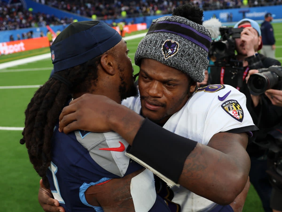 Tennessee Titans running back Derrick Henry and Baltimore Ravens quarterback Lamar Jackson embrace (AP)