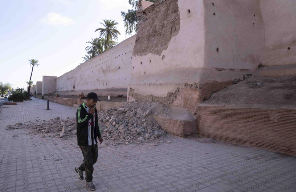 A man walks past a damaged wall of the historic Medina of Marrakech, after after an earthquake in Morocco, Saturday, Sept. 9, 2023. (AP Photo/Mosa’ab Elshamy)