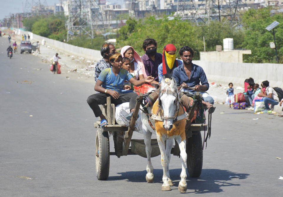 GHAZIABAD, INDIA - MARCH 29: Migrant workers head home on an animal cart during Day 5 of the 21 day nationwide lockdown imposed by PM Narendra Modi to curb the spread of coronavirus, at NH9 road, on March 29, 2020 in Ghaziabad, India. (Photo by Sakib Ali/Hindustan Times via Getty Images)