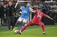 St. Louis City SC defender John Nelson (14) defends against Charlotte FC forward Kerwin Vargas (18) during the second half of an MLS soccer match Saturday, March 4, 2023, in St. Louis. (AP Photo/Joe Puetz)