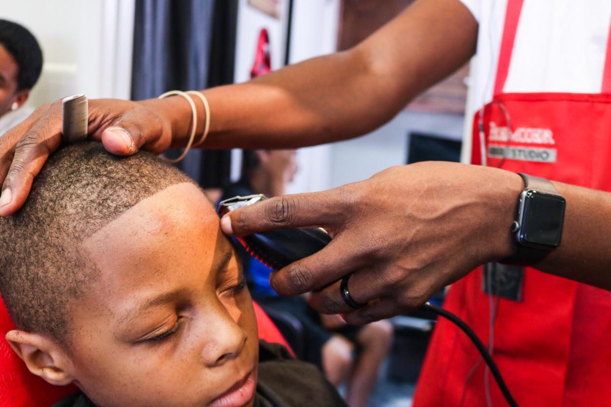Kids in Cleveland were treated to free back-to-school haircuts and school supplies at Premier Barber Studio over the weekend. (Photo: Courtesy Ronald Bridges and Jermaine Smith)