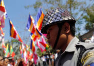 A police stands guard during a protest by Buddhist monks and activists from Myanmar in front of the Thai embassy in Yangon, Myanmar, against the Thai military government invoking a special emergency law to let authorities search the Dhammakaya Temple in an attempt to arrest a former abbot, February 24, 2017. REUTERS/Soe Zeya Tun