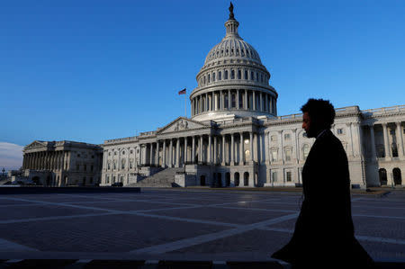 People walk by the U.S. Capitol building in Washington, U.S., February 8, 2018. REUTERS/ Leah Millis