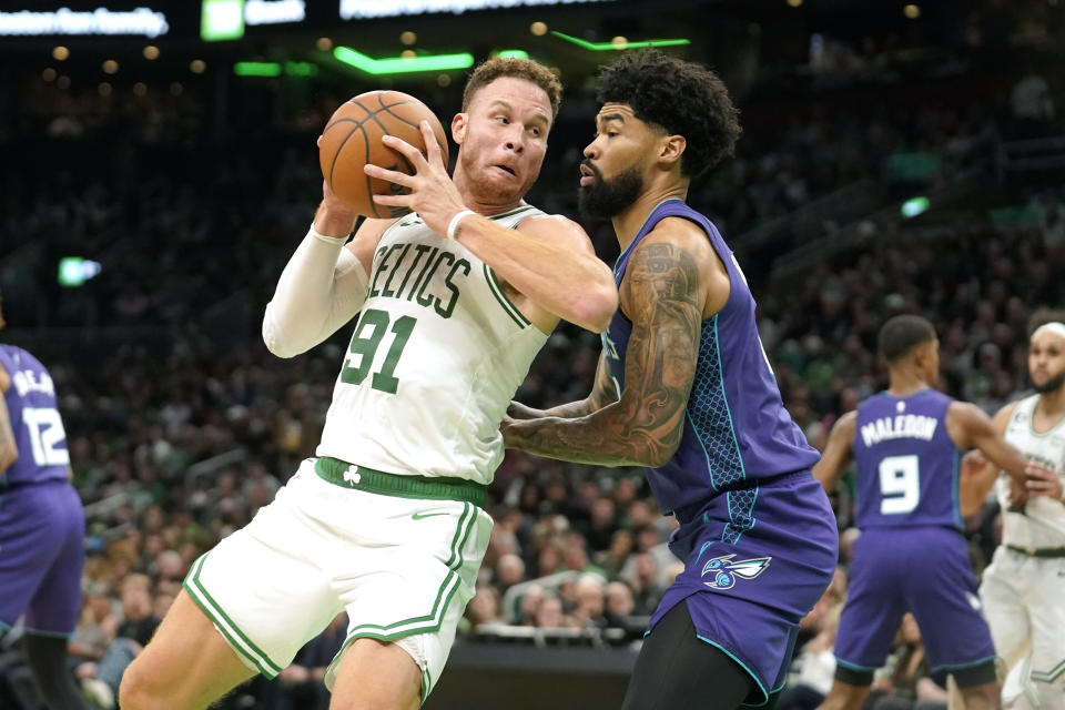 Boston Celtics forward Blake Griffin (91) looks for an opening around Charlotte Hornets center Nick Richards, right, during the first half of an NBA basketball game, Monday, Nov. 28, 2022, in Boston. (AP Photo/Steven Senne)