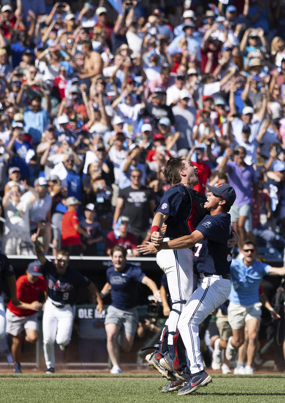 Mississippi catcher Hayden Dunhurst, left, leaps with closing pitcher Brandon Johnson after the final out against Oklahoma to win Game 2 of the NCAA College World Series baseball finals, Sunday, June 26, 2022, in Omaha, Neb. (AP Photo/Rebecca S. Gratz)