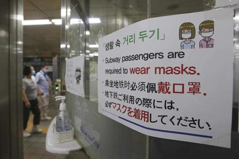 A notice on precautions against the new coronavirus is displayed at a subway station in South Korea, Monday, June 22, 2020. The sign at top reads: "Social distance." (AP Photo/Ahn Young-joon)